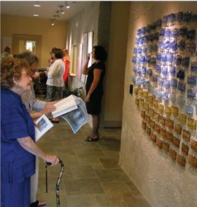 Family members view tribute tiles at Lower Cape Fear LifeCare's SECU Hospice House of Brunswick in Bolivia, NC.