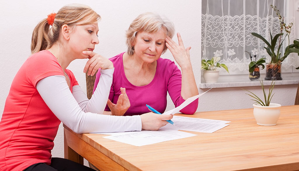 Two Women Wonder What Is A Living Will While They Read Legal Documents